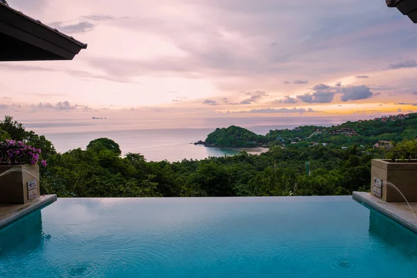 luxury vacation in Thailand pool of a luxury pool villa, swimming pool during vacation at the tropical islands Infinity pool during sunset