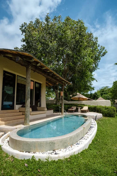 Infinity pool in looking out over the ocean, luxury vacation , private pool villa