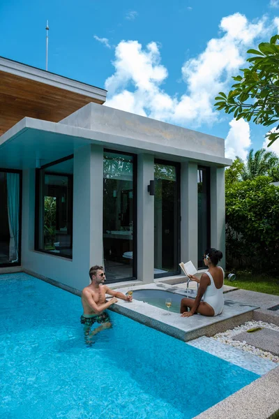 couple men and women on a luxury vacation at a pool villa. men and woman by swimming pool