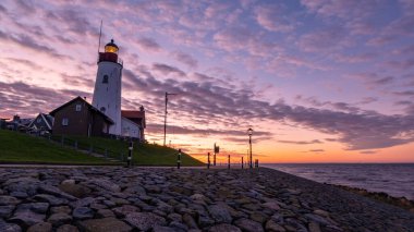 Urk Flevoland Netherlands sunset at the lighthouse and harbor of Urk Holland. Fishing village Urk