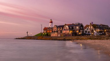 Urk Flevoland Netherlands sunset at the lighthouse and harbor of Urk Holland. Fishing village Urk