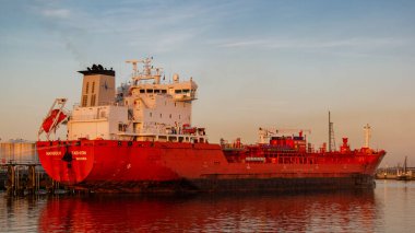Rotterdam Netherlands June 2020, Oil harbor with chemical carriers in the port of Rotterdam during sunrise in the harbor, huge oil tanks to store gas and oil