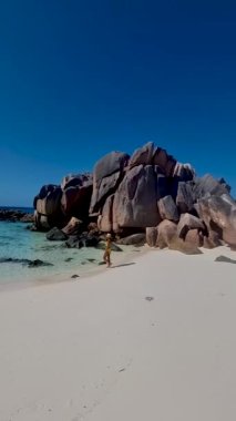 Anse Cocos, La Digue Seychelles, young Asian woman on a tropical beach during a luxury vacation in the Seychelles. . Tropical white beach