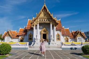 Bangkok Tayland 'daki Wat Benchamabophit tapınağı, Bangkok' taki Mermer Tapınak. Şapkalı Asyalı kadın Bangkok 'taki tapınağı ziyaret ediyor.