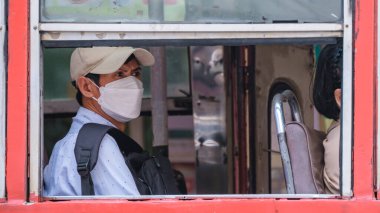 Bangkok Thailand July 2022 people with mas in a red bus public transport during covid 19 pandemic. people using public transport with face mask