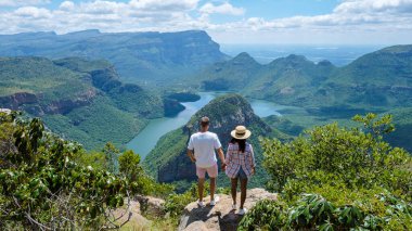 Panorama Route South Africa, Blyde river canyon with the three rondavels, view of three rondavels and the Blyde river canyon in South Africa. Asian women and Caucasian men on vacation in South Africa clipart