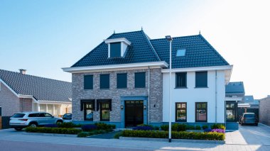 Dutch Suburban area with modern family houses, newly build modern family homes in the Netherlands, dutch family houses in the Netherlands, newly build streets with modern houses. 