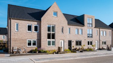 Dutch Suburban area with modern family houses, newly build modern family homes in the Netherlands, dutch family houses in the Netherlands, newly build streets with modern houses. 