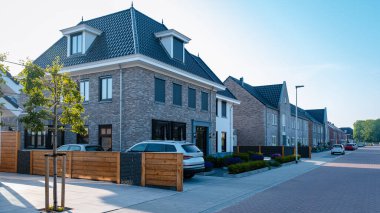 Dutch Suburban area with modern family houses, newly build modern family homes in the Netherlands, dutch family houses in the Netherlands, newly build streets with modern houses. 
