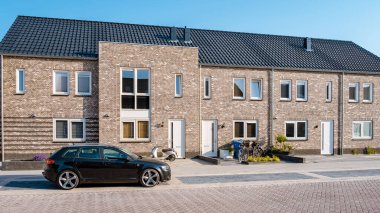 Dutch Suburban area with modern family houses, newly build modern family homes in the Netherlands, dutch family houses in the Netherlands, newly build streets with modern houses. 