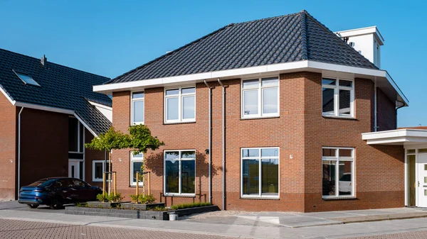 Dutch Suburban area with modern family houses, newly build modern family homes in the Netherlands, dutch family houses in the Netherlands, newly build streets with modern houses.