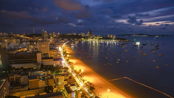 Pattaya Thailand May 2022, beach road during sunset at a tropical beach with palm trees. Pattaya Thailand skyline of the city. 