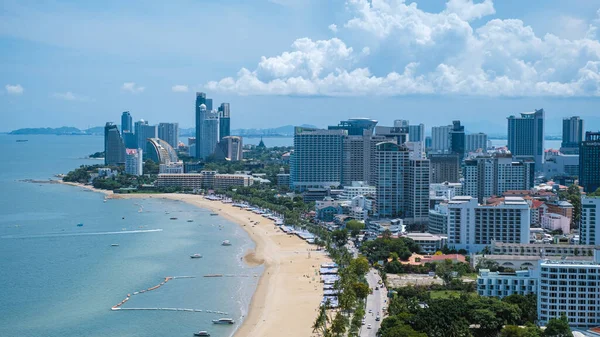 Pattaya Thailand May 2022, beach road during sunset at a tropical beach with palm trees. Pattaya Thailand skyline of the city. 