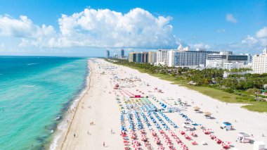 Drone aerial view at Miami South Beach Florida. Beach with colorful chairs and umbrellas, top view of the beach Miami Florida