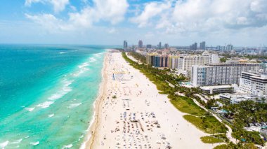 Drone aerial view at Miami South Beach Florida. Beach with colorful chairs and umbrellas, top view of the beach Miami Florida