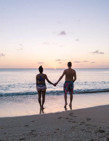 young couple on vacation in Saint Lucia, luxury holiday Saint Lucia Caribbean, men and woman on vacation at the tropical Island of Saint Lucia Caribbean. Calabash beach St Lucia Caribbean