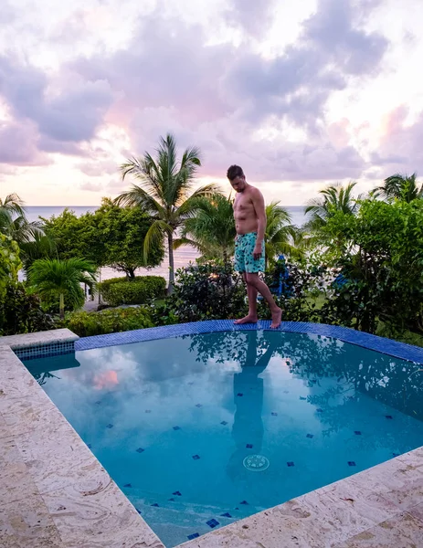 Young Men Watching Sunset Reflection Pool Saint Lucia Caribbean Men — Stockfoto