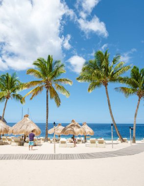 Sugar beach Saint Lucia, is a public white tropical beach with palm trees and luxury beach chairs on the beach of the Island St Lucia Caribbean. 