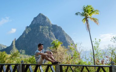 Caucasian men and a view at the Pitons of St Lucia Saint Lucia, men hiking in the mountains of Saint Lucia Caribbean, and a nature trail in the jungle of Saint Lucia. 