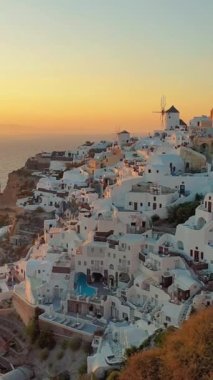 Sunset in Oia Santorini Greece during summer. whitewashed building and church during sunset in Greece the famous caldera during sunset