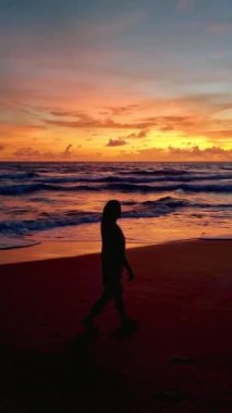 women silhouette sunset on the tropical beach of Koh Lanta Thailand during a vacation in Thailand. Koh Lanta Island Thailand