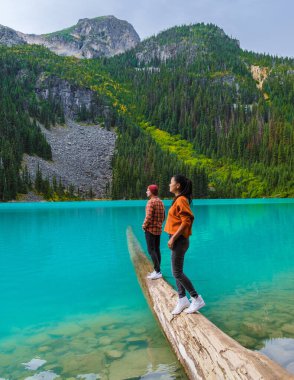 Joffre Lakes British Colombia Whistler Canada, colorful lake of Joffre lakes national park in Canada. Couple of Asian women and caucasian men walking at Jofre Lake BC Canada