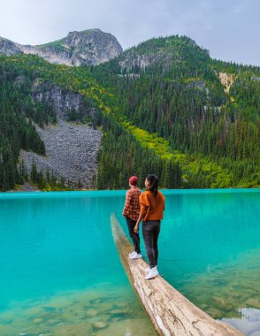 Joffre Lakes British Colombia Whistler Canada, colorful lake of Joffre lakes national park in Canada. Couple of Asian women and caucasian men walking at Jofre Lake BC Canada