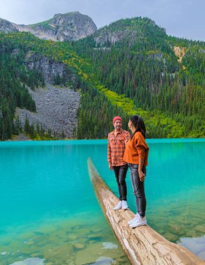 Joffre Lakes British Colombia Whistler Canada, colorful lake of Joffre lakes national park in Canada. Couple of Asian women and caucasian men walking at Jofre Lake BC Canada