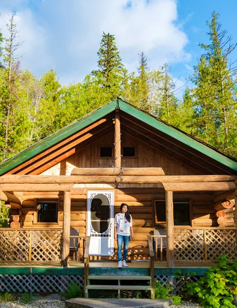 Wooden hut in an autumn forest, cabin off the grid, wooden cabin circled by colorful yellow and red fall trees. cabin in the woods British Colombia Canada Autumn.