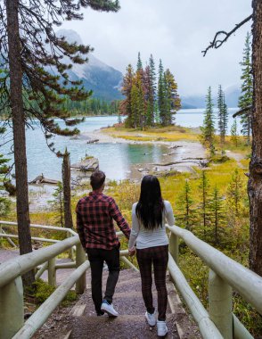 Spirit Island in Maligne Lake, Jasper National Park, Alberta, Canada. The Canadian Rockies. Asian women and caucasian men visit Maligne lake during the autumn and fall season