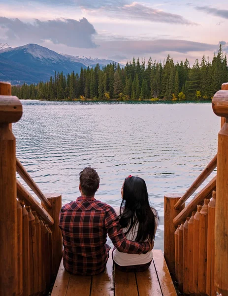 couple at Beauvert lake, sunrise by the lake at Jasper, Lac Beauvert Alberta Canadian Rockies Canada. men and women watching the sunrise by the lake in Jasper Canada