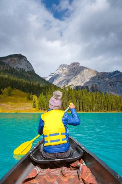 Emerald lake Yoho national park Canada British Colombia. beautiful lake in the Canadian Rockies during the Autumn fall season. Women in canoe kayaking at the lake