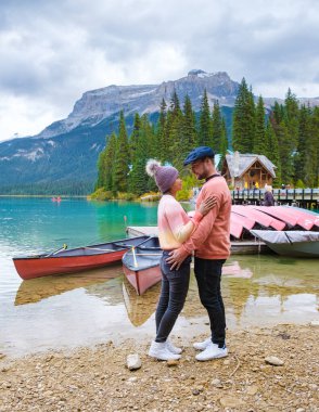 Emerald lake Yoho national park Canada British Colombia. beautiful lake in the Canadian Rockies during the Autumn fall season. Couple of men and women standing by the lake