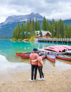 Emerald lake Yoho national park Canada British Colombia. beautiful lake in the Canadian Rockies during the Autumn fall season. Couple of men and women standing by the lake