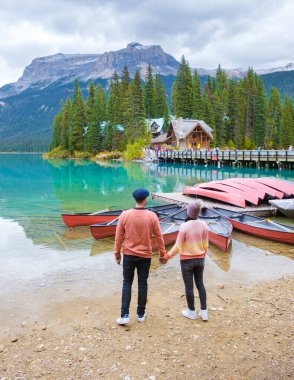 Emerald lake Yoho national park Canada British Colombia. beautiful lake in the Canadian Rockies during the Autumn fall season. Couple of men and women standing by the lake