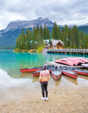 Emerald lake Yoho national park Canada British Colombia. beautiful lake in the Canadian Rockies during the Autumn fall season. Asian women looking out over Emerald lake