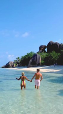 young couple on vacation in Seychelles, luxury holidaySeychelles, men and woman on vacation at the tropical Island of La Digue Seychelles