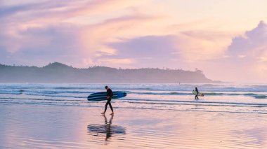 Tofino Vancouver Island Pacific rim coast, surfers with surfboard during sunset at the beach, surfers silhouette Canada Vancouver Island Tofino Vancouver Islander Island