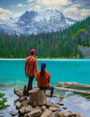 Joffre Lakes British Colombia Whistler Canada, colorful lake of Joffre lakes national park in Canada. Couple of Asian women and caucasian men walking at Jofre Lake BC Canada