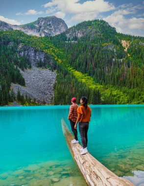 Joffre Lakes British Colombia Whistler Canada, colorful lake of Joffre lakes national park in Canada. Couple of Asian women and caucasian men walking at Jofre Lake BC Canada