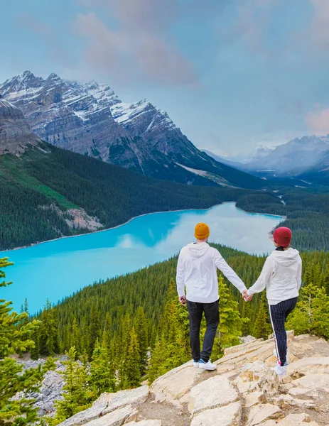 Lake Peyto in Banff National Park, Canada. Mountain Lake as a fox head is popular among tourists in Canada driving the icefields parkway. A couple of men and women looking out over the lake