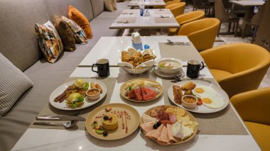 Breakfast buffet in a luxury hotel. top view of breakfast table with eggs and bread and coffee. poached eggs meet and croisant top view table