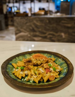 Italian penne pasta with fish and crab on top. Italian pasta