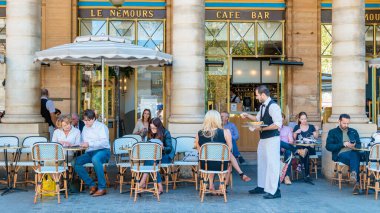 Paris France September 2021, people drinking coffee on the terrace of a cafe restaurant during the Autumn end of summer. 