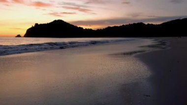 Sunset on a Beach at the tropical island Koh Lanta Krabi Thailand. orange and pink colors during sunset on the beach
