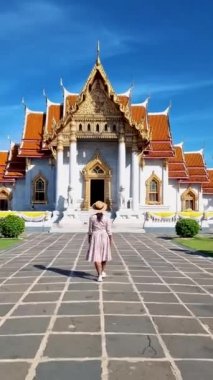 Wat Benchamabophit temple in Bangkok Thailand, The Marble temple in Bangkok Thailand, couple men and women visiting the Marble temple in Bangkok