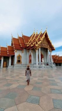 Wat Benchamabophit temple in Bangkok Thailand, The Marble temple in Bangkok Thailand, couple men and women visiting the Marble temple in Bangkok