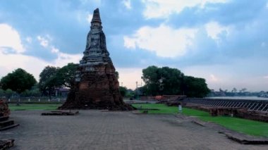 High water at the river in Ayutthaya, Thailand at Wat Chaiwatthanaram during sunset in Ayutthaya Thailand during the monsoon rain season,high water protection wall by river