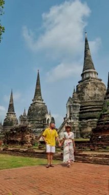 Ayutthaya, Thailand at Wat Phra Si Sanphet, a couple of men and women with a hat visiting Ayyuthaya Thailand. Tourist with map in Thailand