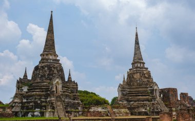 Ayutthaya, Thailand at Wat Phra Si Sanphet, a couple of men and women with a hat visiting Ayyuthaya Thailand. Tourist with map in Thailand